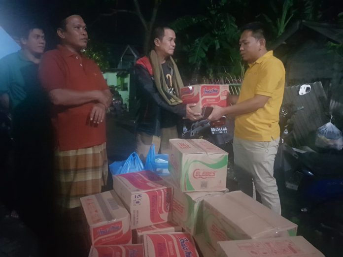 FOTO: Kanan, H. Ismail (Bendahara) Pengurus DPD II Partai Golkar Makassar saat memberikan bantuan kepada ketua RW.08 Blok X Perumnas Antang. Rabu, (8/12)