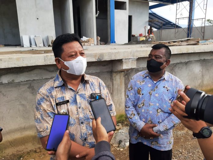 Camat Marusu Suwardi (kiri) didampingi Kepala Desa Marumpa Bakri Saleh memberikan keterangan di lokasi pembangunan stasiun kereta api jalur Makassar-Parepare di Desa Marumpa, Kecamatan Marusu, Kabupaten Maros, Kamis (16/12/2021). foto: istimewa