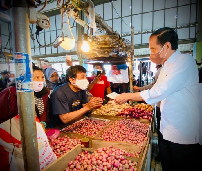 FOTO: Presiden Jokowi memberikan BLT Minyak Goreng kepada sejumlah pedagang kecil dan penerima di Pasar Rakyat Angso Duo Baru, Kota Jambi, Kamis (07/04/2022). (Foto: BPMI Setpres/Laily Rachev)