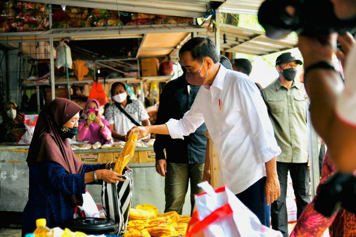 FOTO: Presiden Jokowi menyalurkan bansos bagi penerima manfaat dan para pedagang di Pasar Anom, Sumenep, Rabu (20/04/2022). (Foto: BPMI Setpres/Laily Rachev)