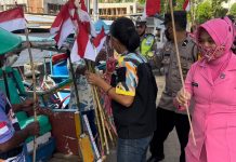 Jelang HUT RI ke 77, Ibu Bhayangkari Ormas GMBI Bagikan Bendera Merah Putih, Kapolsek Turikale: Bangkitkan Nasionalisme FOTO: Pengurus Bhayangkari Ranting Turikale, Hj Asma Mustamin dan Ketua Distrik GMBI Distrik Maros saat membagi bendera merah putih ke para tukang becak di pusat kota Maros. Selasa, (16/8/2022)