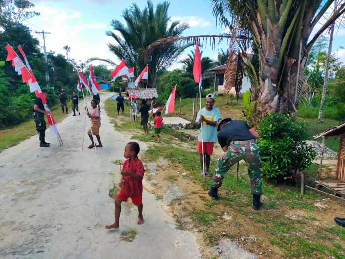 FOTO: Satgas Pamtas Kewilayahan Yonif 623/BWU Pos Bori bersama warga memerah putihkan jalan Kampung Bori, Distrik Aifat, Kabupaten Maybrat, Papua Barat Daya. Senin (7/8/2023).