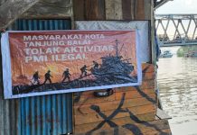 Warga Kota Tanjung Balai Tebarkan Spanduk Menolak PMI Ilegal FOTO: Warga Kota Tanjung Balai menolak aktivitas Pekerja Migran Indonesia (PMI) ilegal di wilayah mereka.